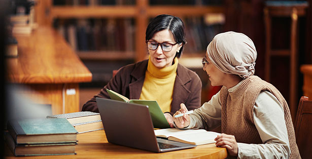 teacher and student in a library