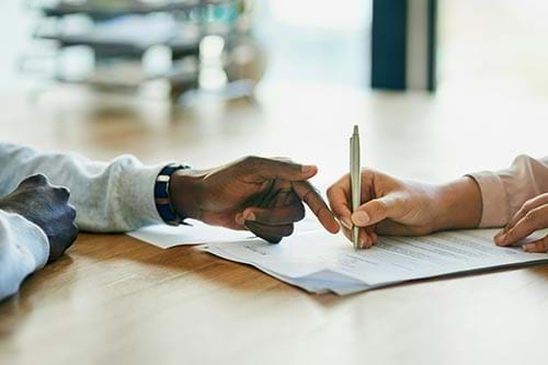 hand signing a paper document