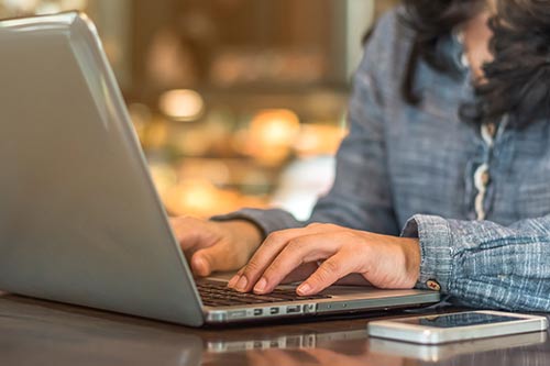 hands on a keyboard laptop