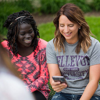 students looking at text message